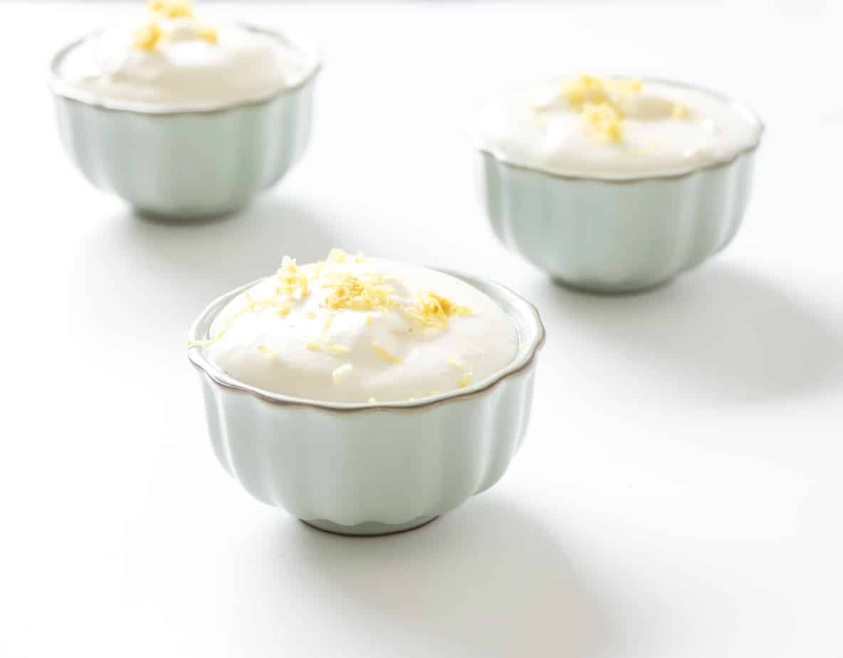 Creamy filling with lemon zest in serving bowls.