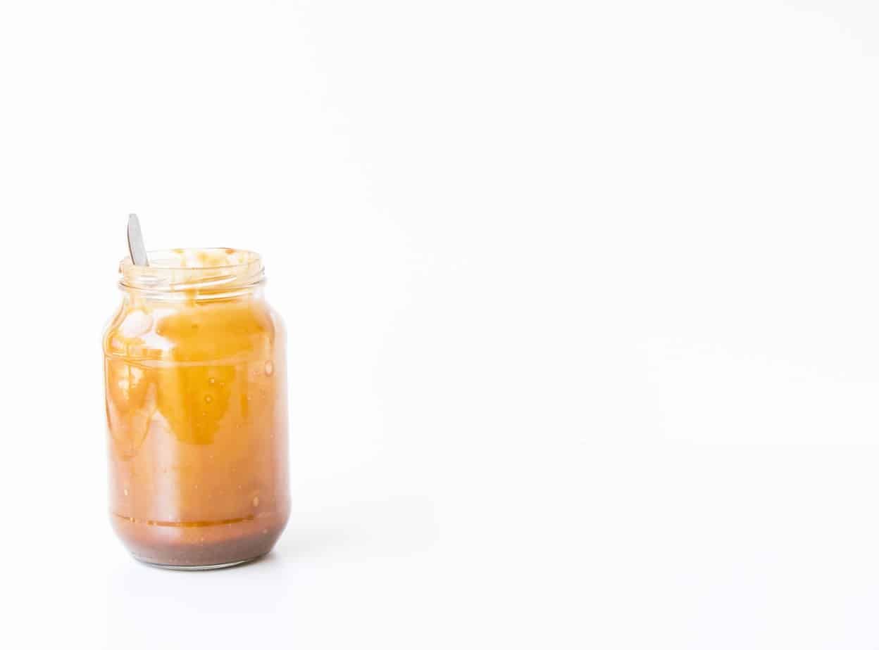 A jar of Vegan Salted Caramel with a silver spoon