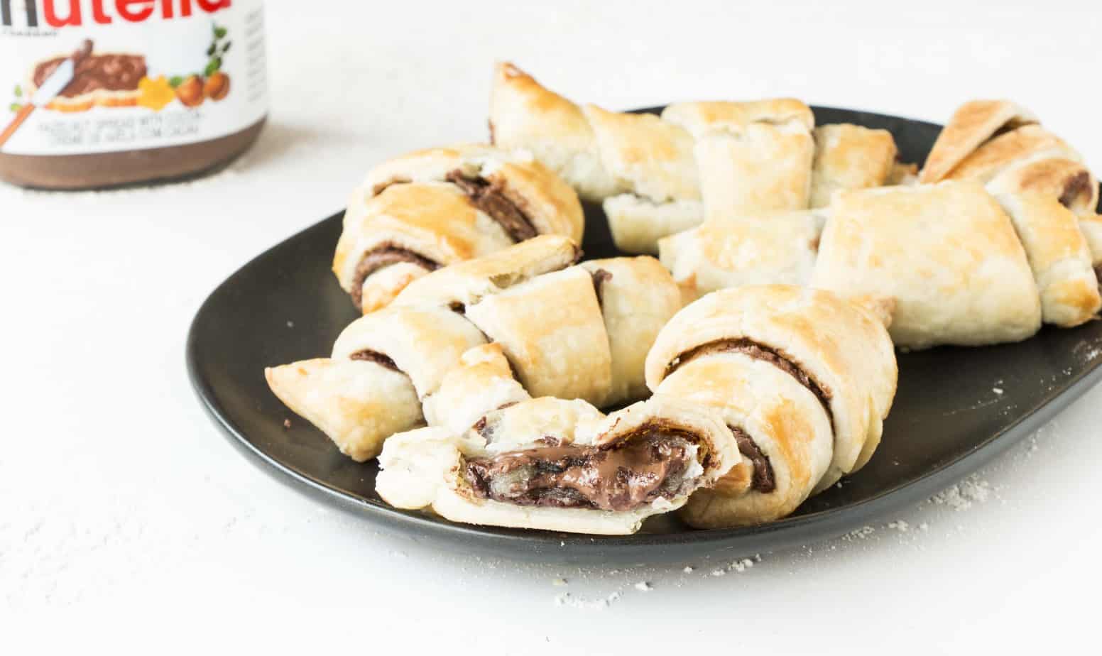 Easy Nutella Croissants on a black plate.