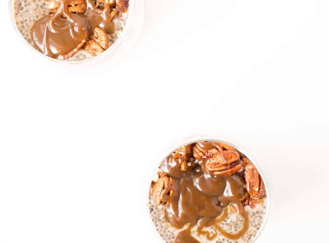 Salted Caramel & Pecan Chia Puddings topped with caramel and pecan nuts.