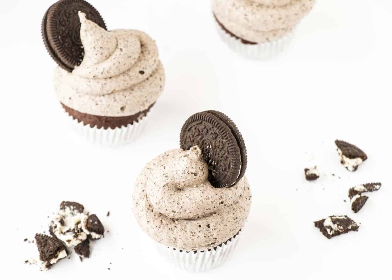 Double Chocolate Oreo Cupcakes with crushed Oreo biscuits around them.