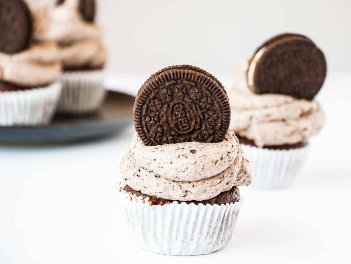 Oreo Cupcakes with frosting and a whole Oreo biscuit as garnish.