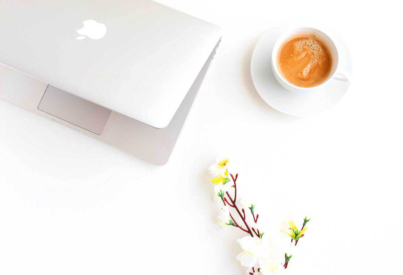 A laptop with a cup of coffee