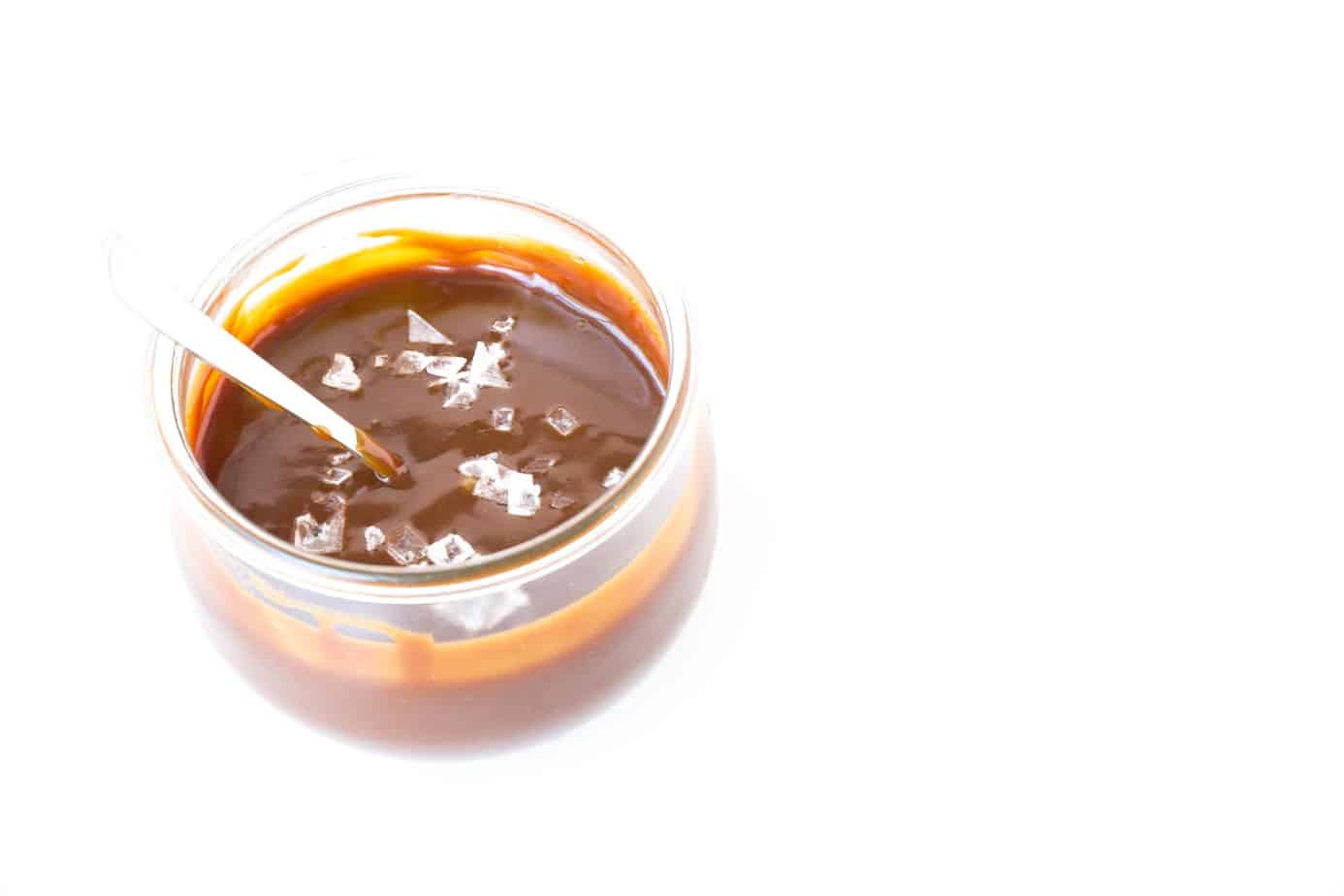 Salted Caramel Sauce with salt flakes and silver spoon