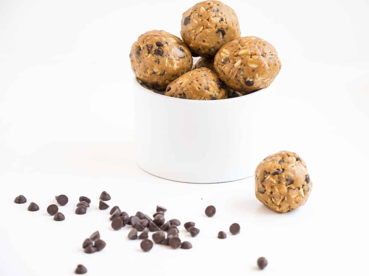 A bowl of energy balls with chocolate chips.