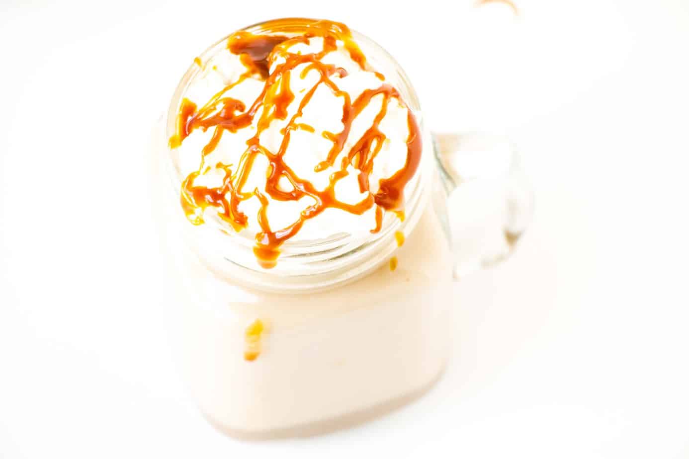 Caramel Pumpkin Spice Latte with sauce and whipped cream.