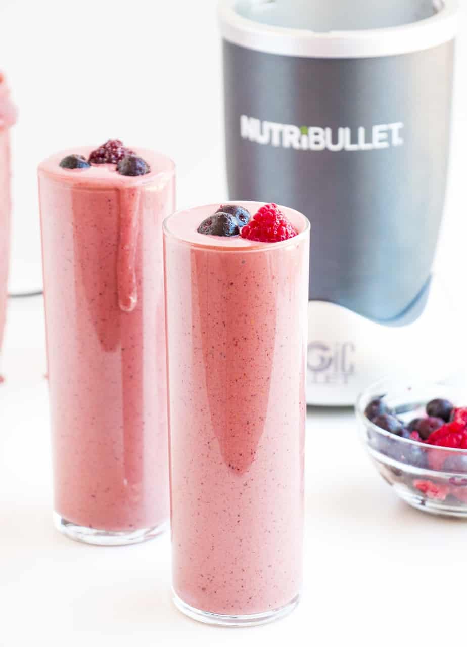 Two acai berry boost smoothies topped with fresh berries.