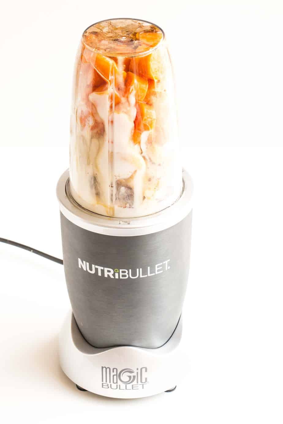 A blender filled with ingredients to make a smoothie.