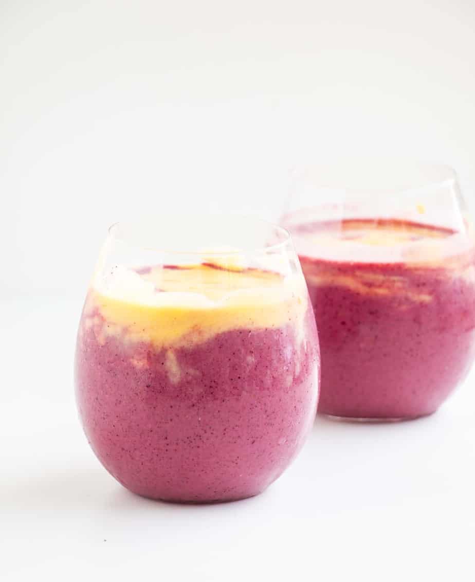 A layered Mango Berry Smoothie.