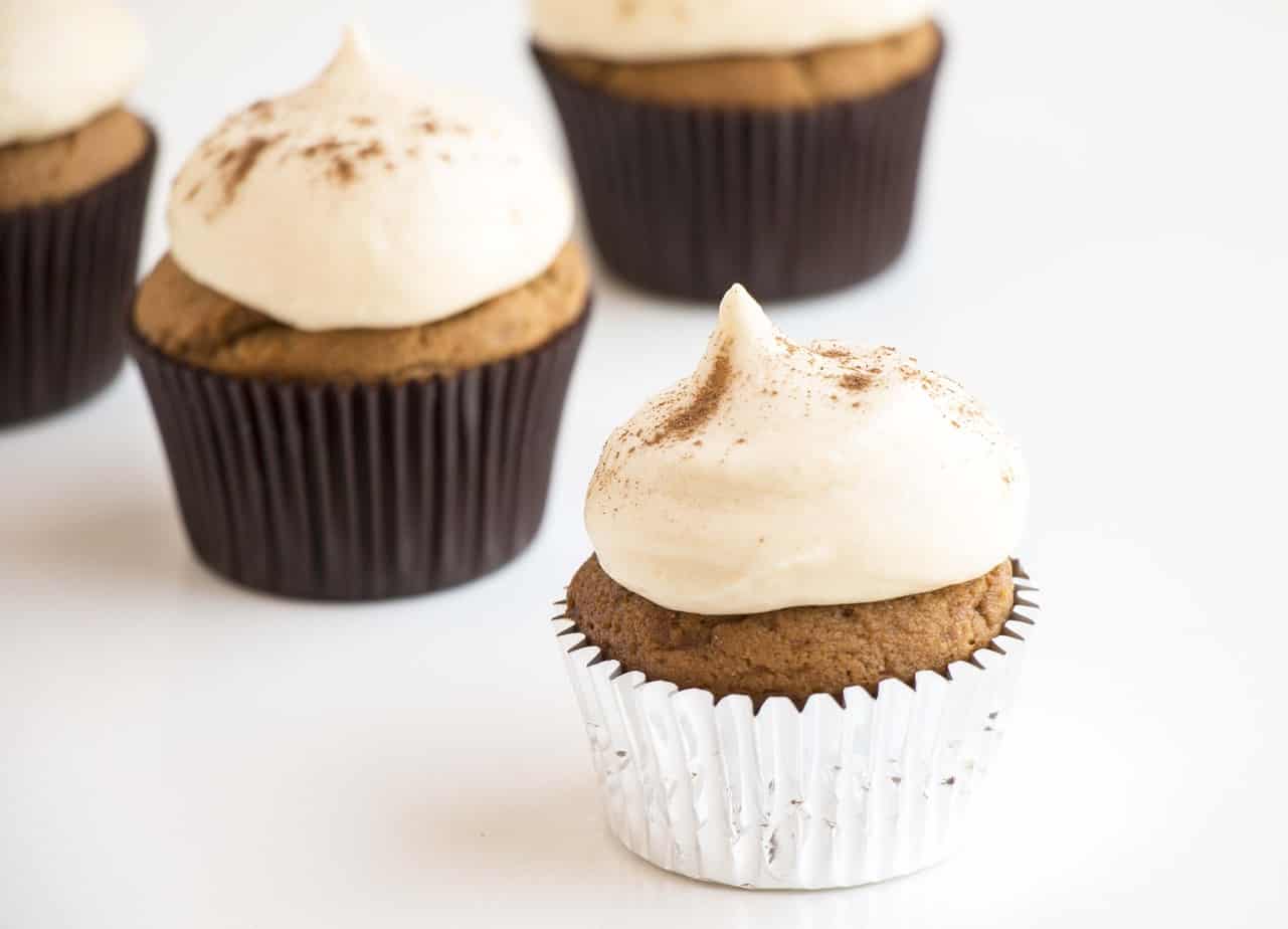 Fluffy Gingerbread Cupcakes with Cream Cheese Frosting in cupcake liners.