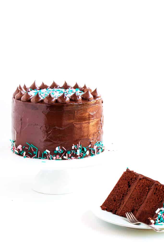 Dark Chocolate Sprinkle Cake - The most scrumptious dark chocolate cake recipe, topped with a creamy fudge frosting. The perfect cake for any and all occasions.