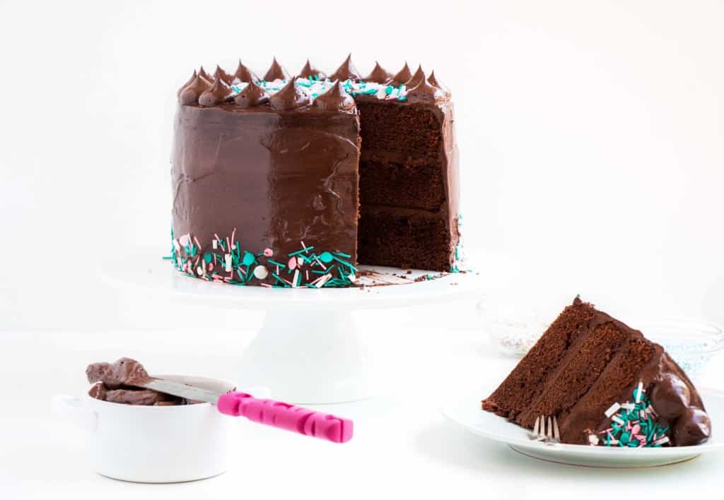 Dark Chocolate Sprinkle Cake - The most scrumptious dark chocolate cake recipe, topped with a creamy fudge frosting. The perfect cake for any and all occasions.