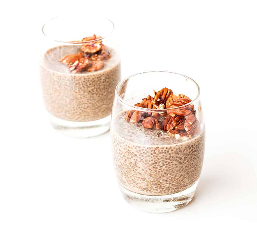 Two Salted Caramel & Pecan Chia Puddings in serving glasses.