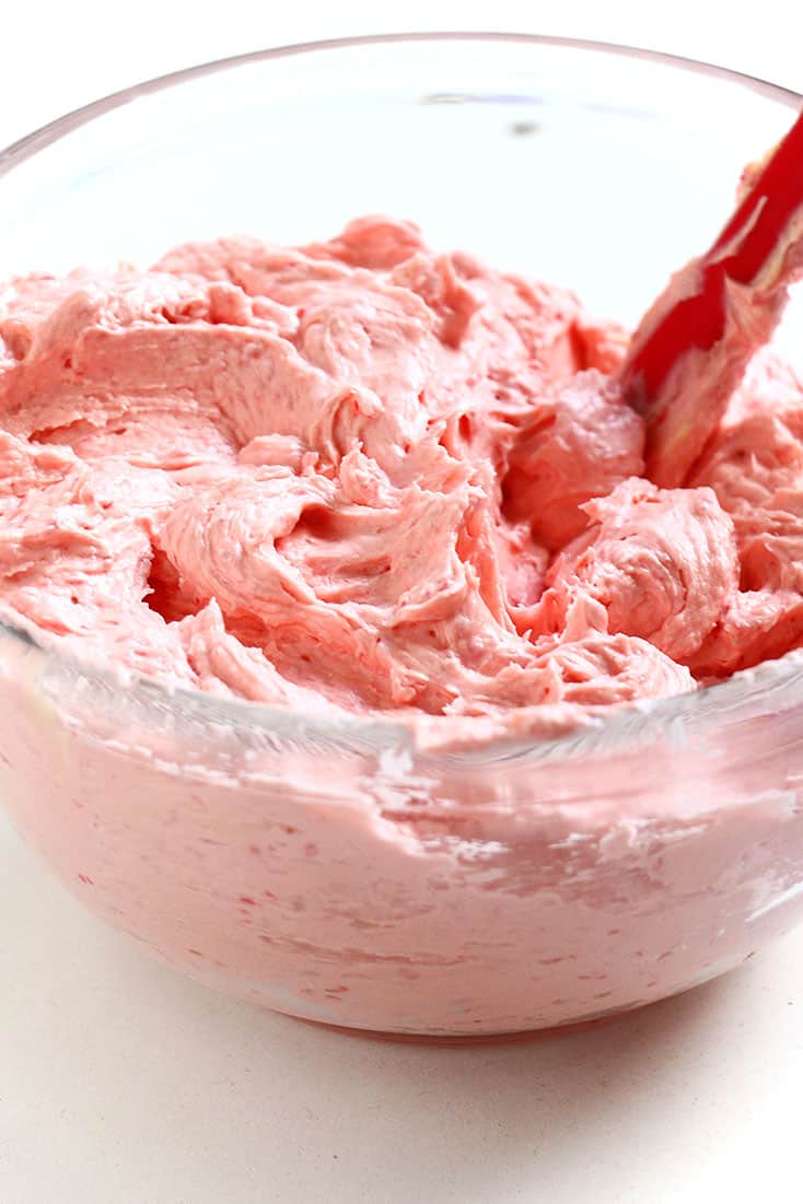  Raspberry Buttercream in a bowl with a spatula.