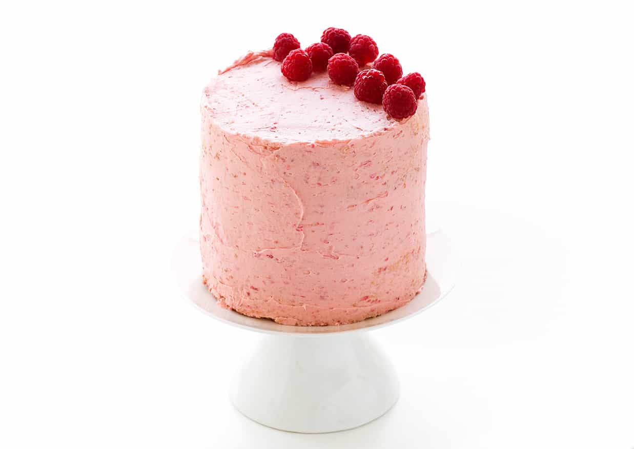 Pink cake on a white cake stand