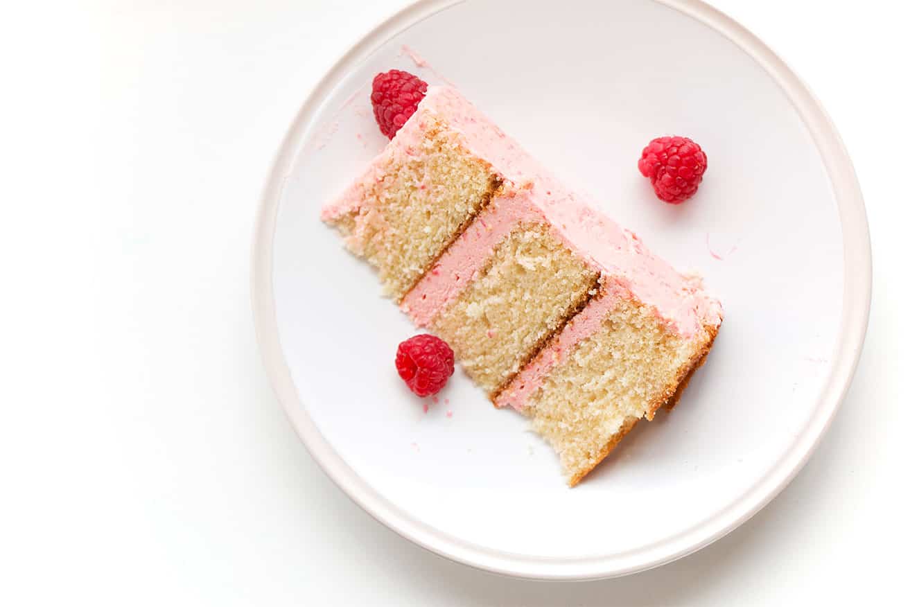 Soft Vanilla Cake with Raspberry Buttercream - A delicious vanilla cake recipe that is easy to make and is perfectly moist and soft. Filled and topped with a delicious and creamy raspberry buttercream.