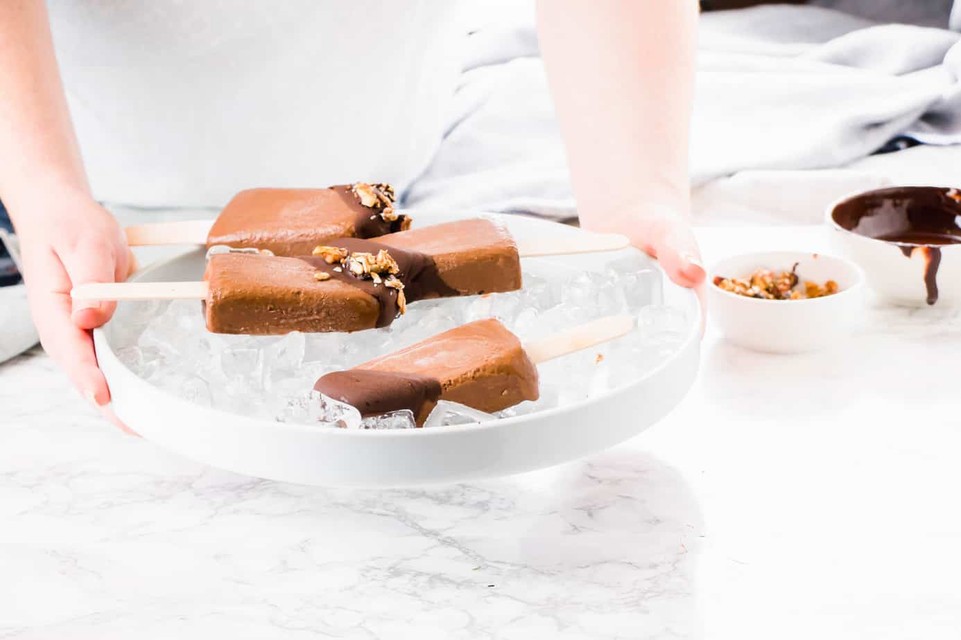 These Vegan Chocolate Protein Popsicles make the best on the go breakfast or the ultimate summer dessert. Made with vegan protein, coconut milk and topped off with dark chocolate ganache and crunchy granola.