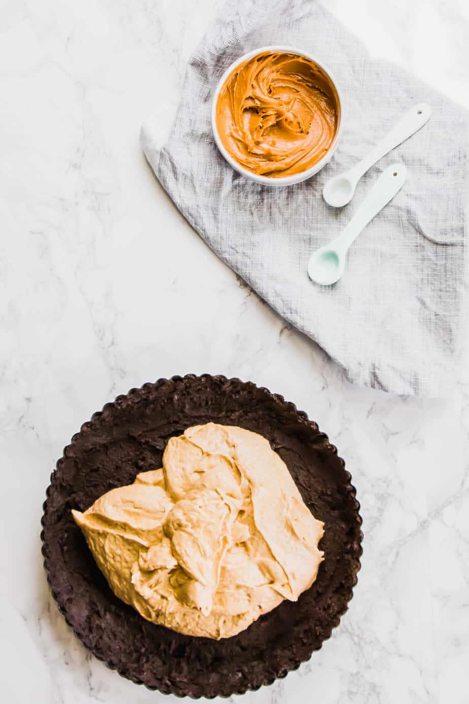 This Vegan Peanut Butter Chocolate Tart is the ultimate no-bake decadence. No one will even know it's vegan! Made with oreos, peanut butter and a little coconut oil and cream! 