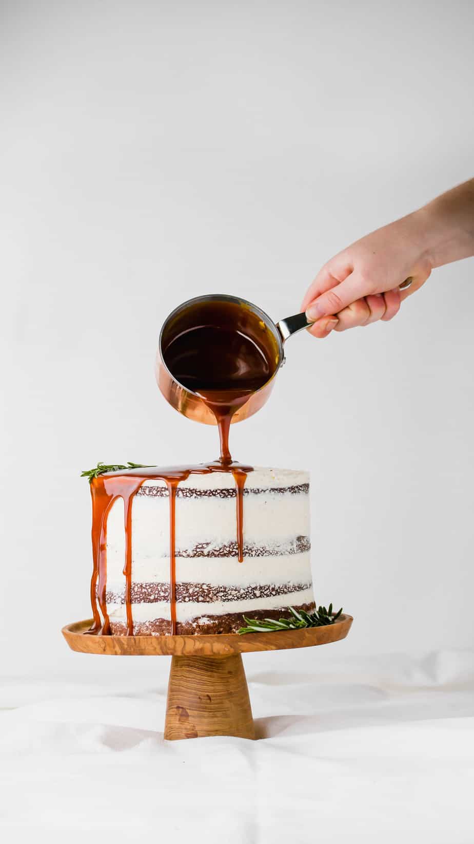 A ginger sponge cake frosted with buttercream and topped with a drizzle of caramel sauce.
