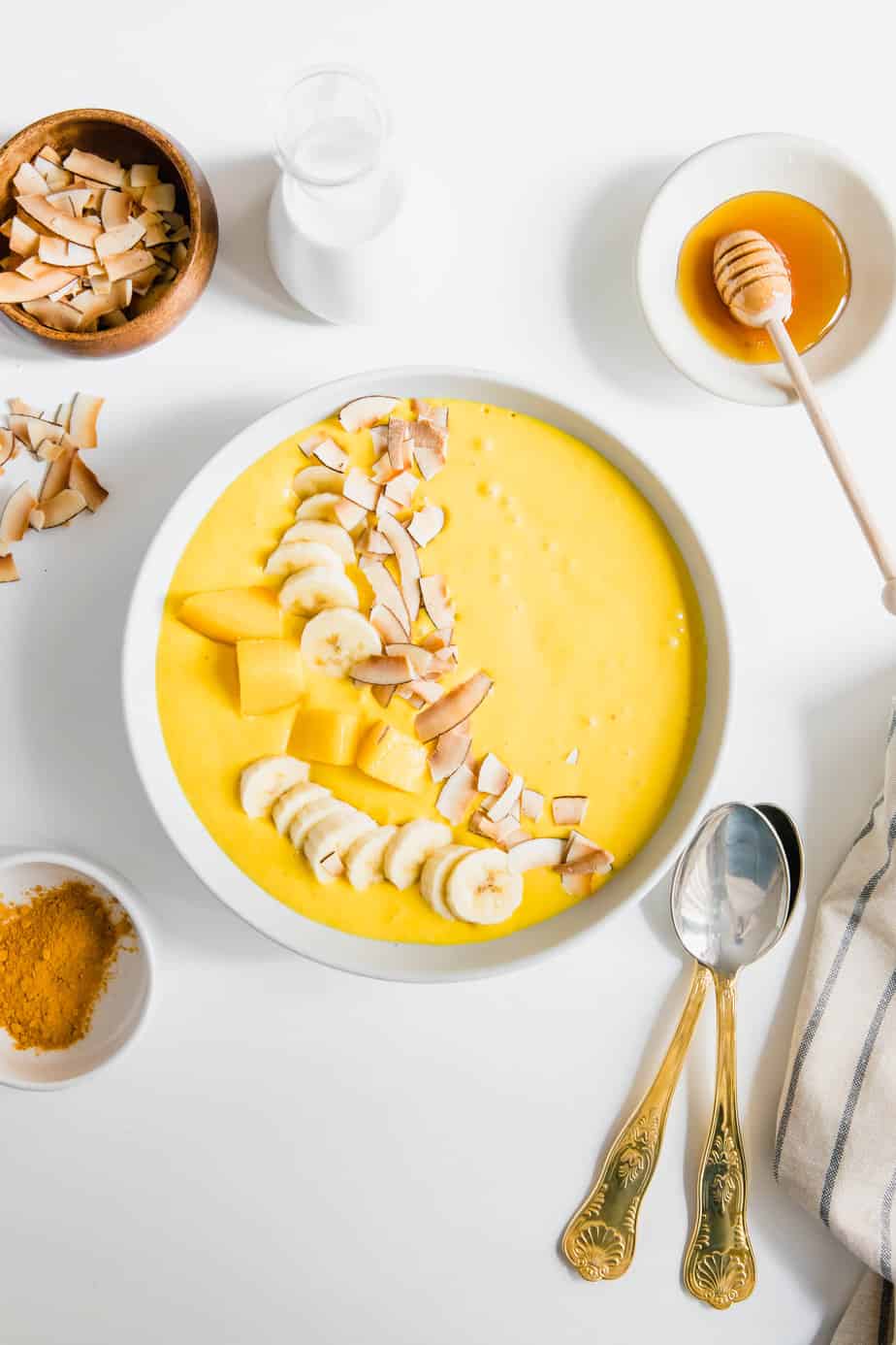 This Creamy Coconut Turmeric Smoothie Bowl is my favourite breakfast for this time of year. Made with coconut milk, fresh ginger, banana and mango, it's the perfect healthy, vegan breakfast.