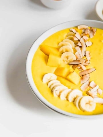 This Creamy Coconut Turmeric Smoothie Bowl is my favourite breakfast for this time of year. Made with coconut milk, fresh ginger, banana and mango, it's the perfect healthy, vegan breakfast.