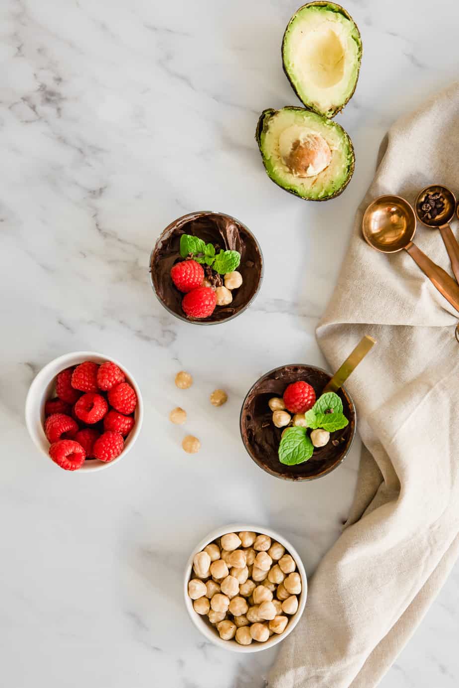 Chocolate mousse with avocados and raspberries on marble.