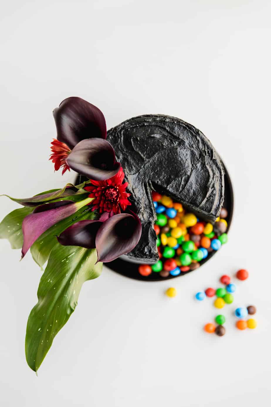 Layers of velvety black, moist cake, covered in the softest black frosting and of course filled with my favourite Skittles & M&M's! This is the ultimate Halloween cake, with a classy twist of course!