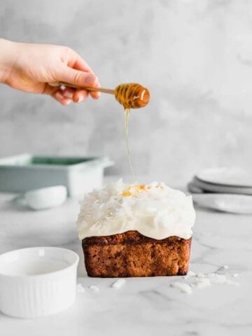 This life-changing Honey Carrot Coconut Loaf is the only Easter recipe you will ever need. Made with coconut milk, fresh carrots and topped with the best cream cheese frosting.