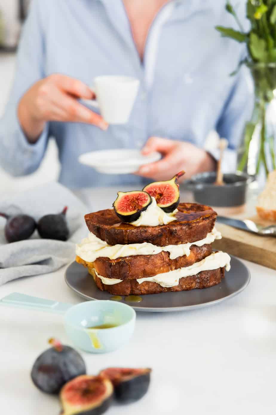 A stack of French toast with cream and fresh figs.