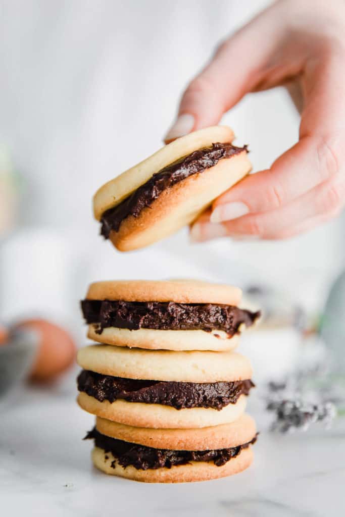 Vanilla Sandwich Cookies with Chocolate Ganache. Buttery vanilla cookies are sandwiched with rich & creamy chocolate ganache and stacked on top of each other.