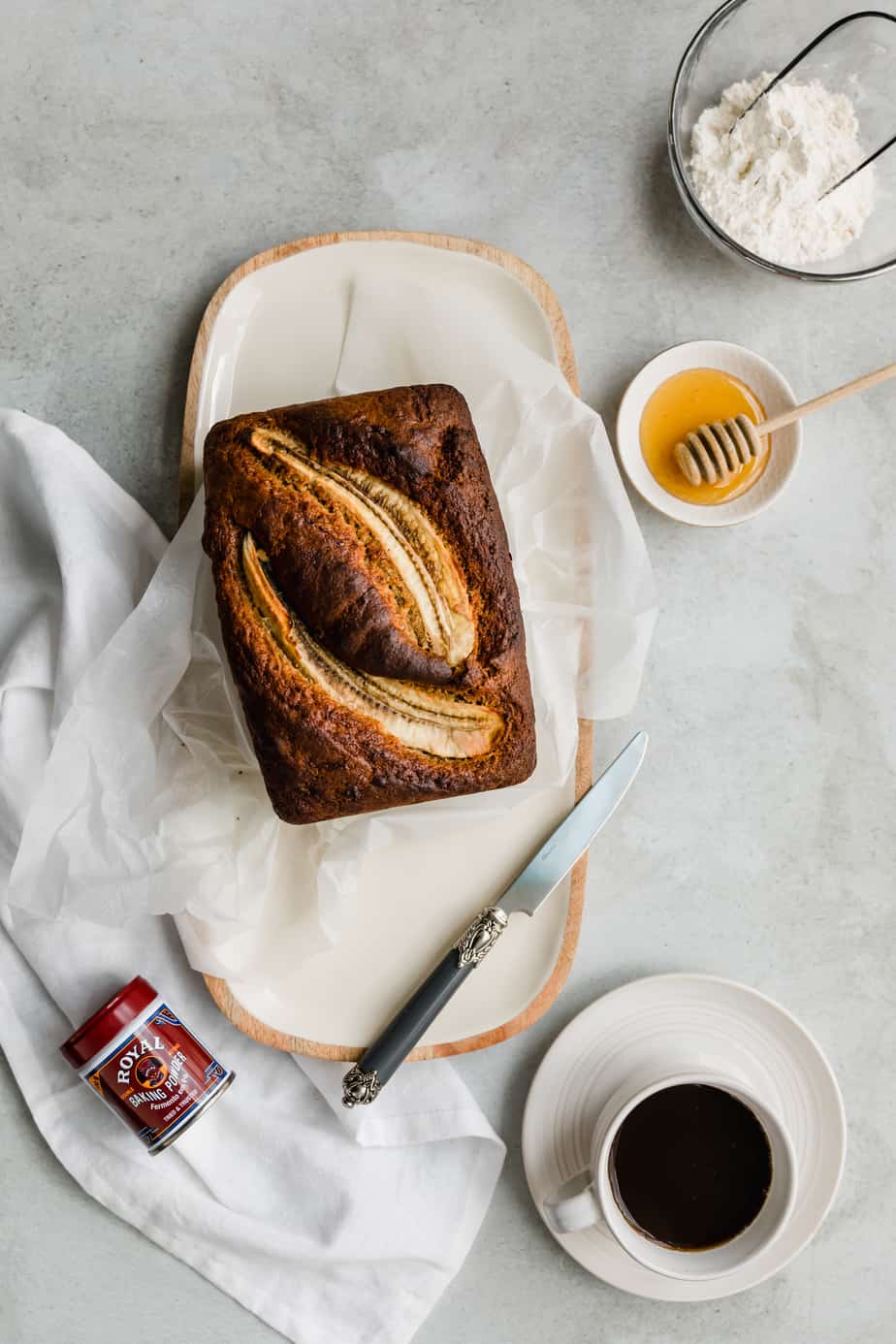 A loaf of banana bread on baking paper.