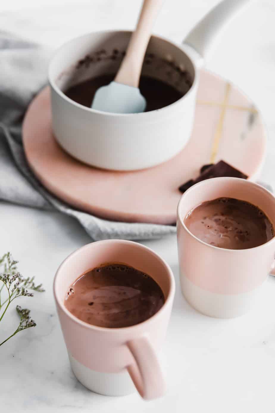 Two mugs filled with spiced chai hot chocolate