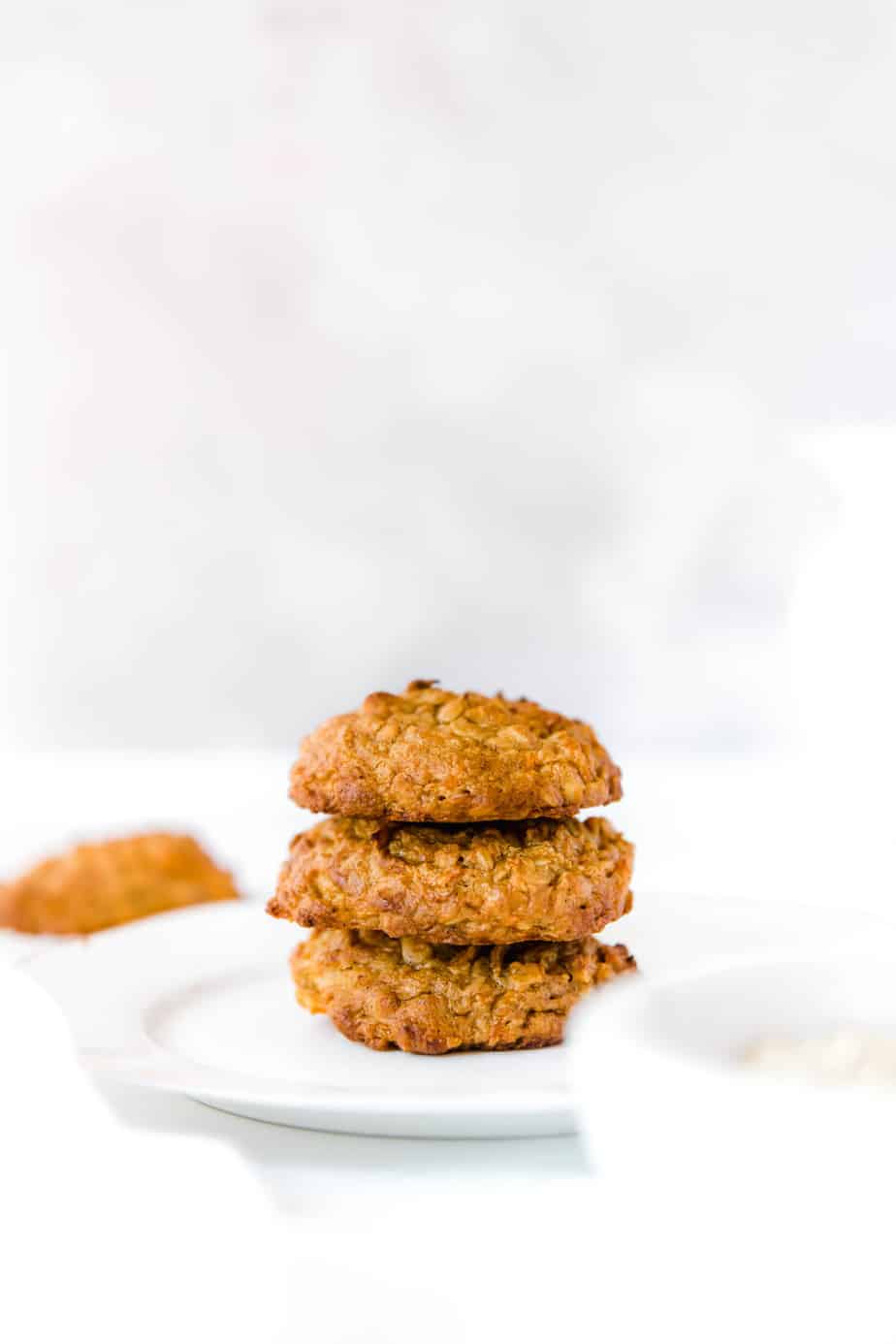 A stack of Healthy Cinnamon Carrot Cookies on a white plate.