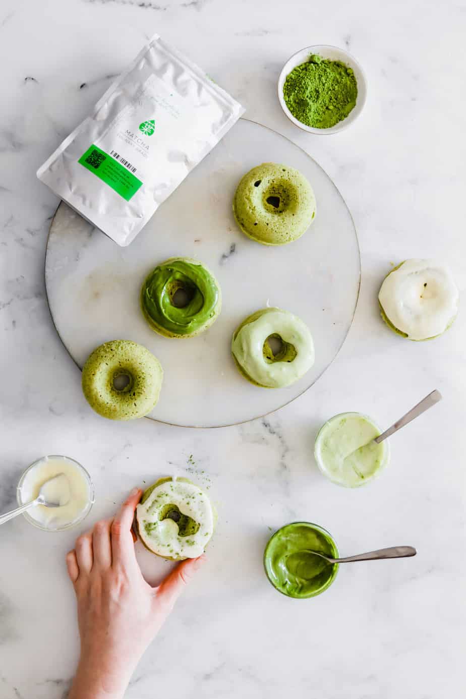 Baked matcha donuts with cream cheese glaze in varying shades of grey.