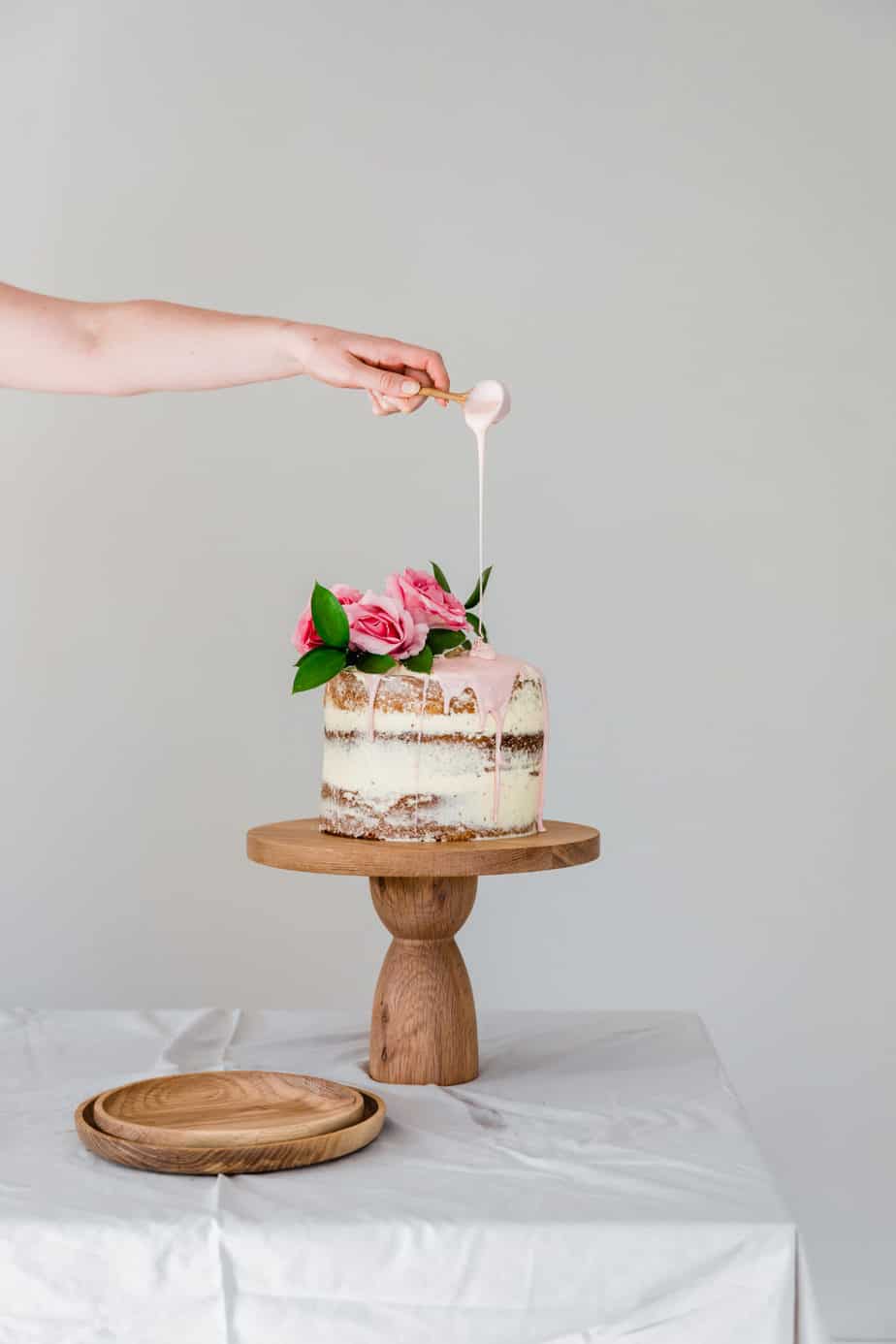 Rose & Vanilla Naked Cake on wooden cake stand.