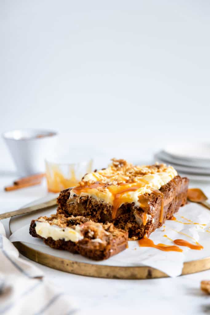 This easy Gluten-Free Apple Cinnamon Loaf Cake is deliciously moist and full of chunks of fresh apples and cozy cinnamon flavour. Pile on the dreamy cream cheese frosting and a drizzle of caramel and it is the perfect companion to a warm cup of tea or coffee. 
