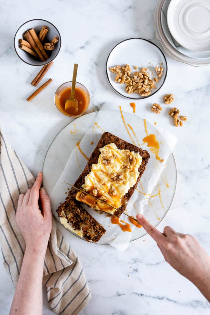 This easy Gluten-Free Apple Cinnamon Loaf Cake is deliciously moist and full of chunks of fresh apples and cozy cinnamon flavour. Pile on the dreamy cream cheese frosting and a drizzle of caramel and it is the perfect companion to a warm cup of tea or coffee. 