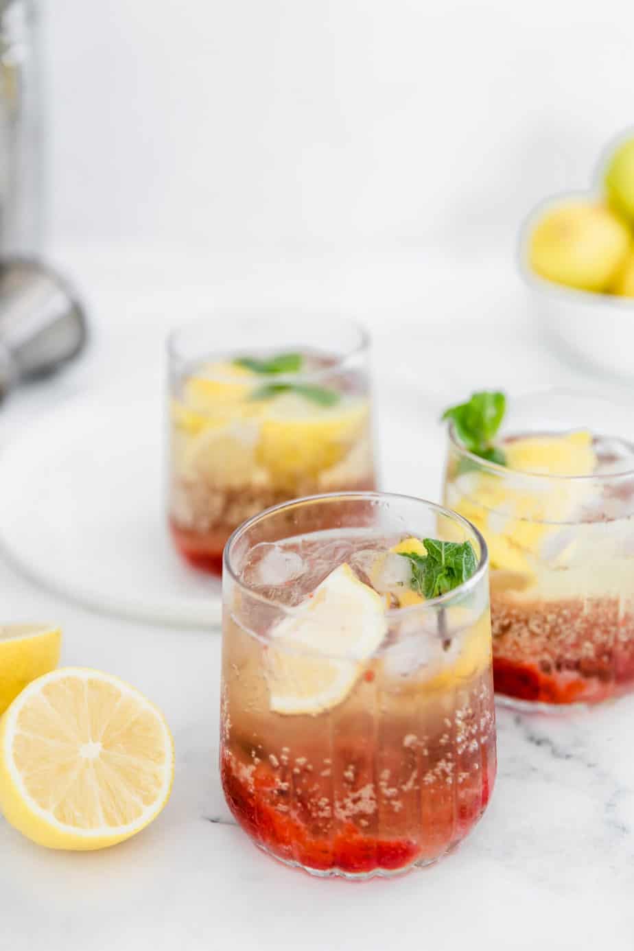 A vodka cocktail with strawberries and mint.