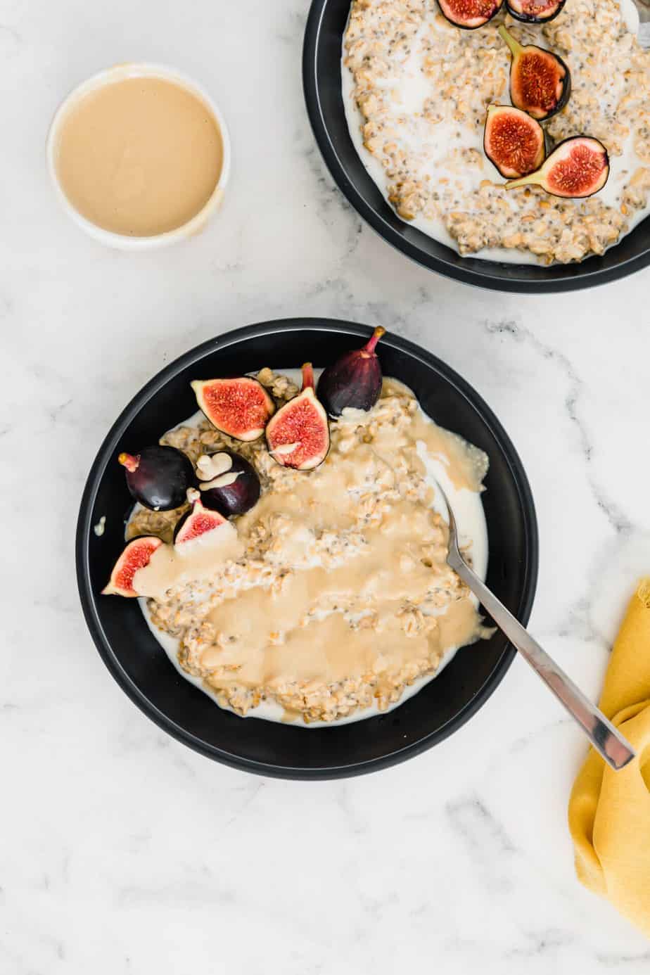 A bowl of overnight oats with tahini and fresh figs.