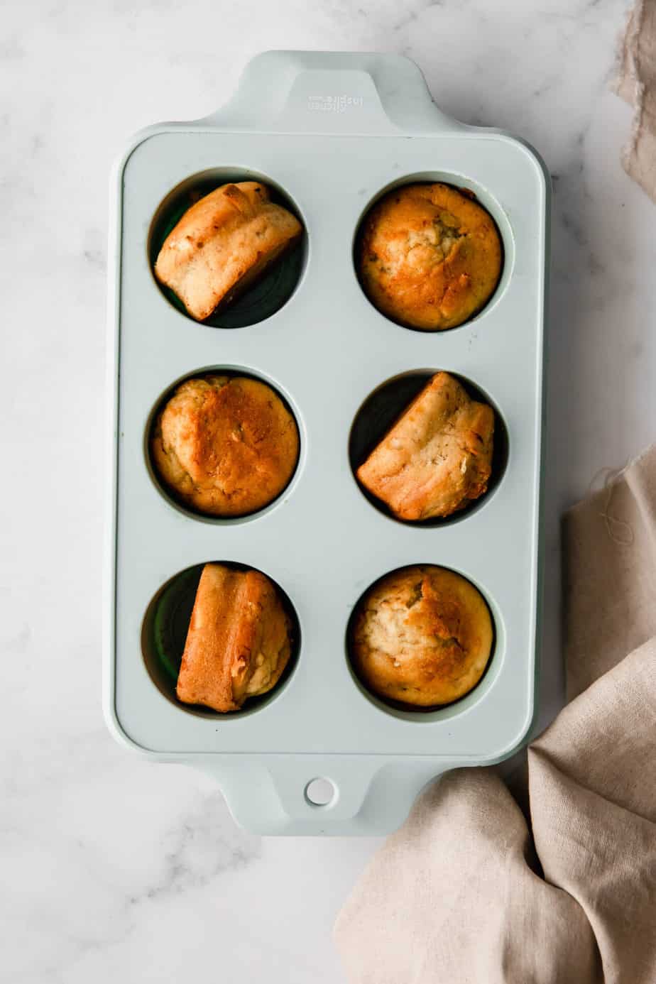 Easy Moist Banana Muffins made using a Thermomoix in blue muffin tray.
