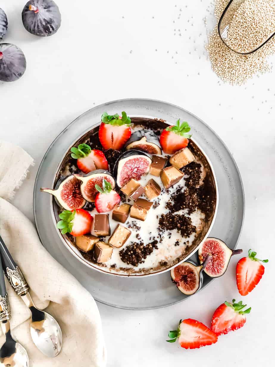 A bowl of chocolate porridge with milk and fresh fruit.