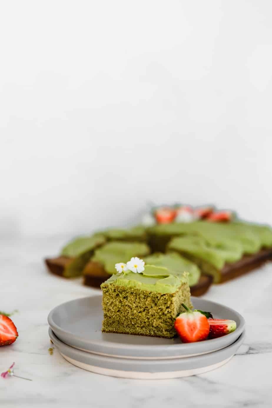 Easy Matcha Sheet Cake with berries and flowers.