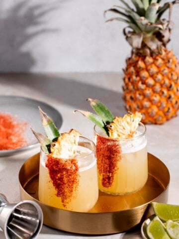 gold tray with mezcalita cocktails and pineapple