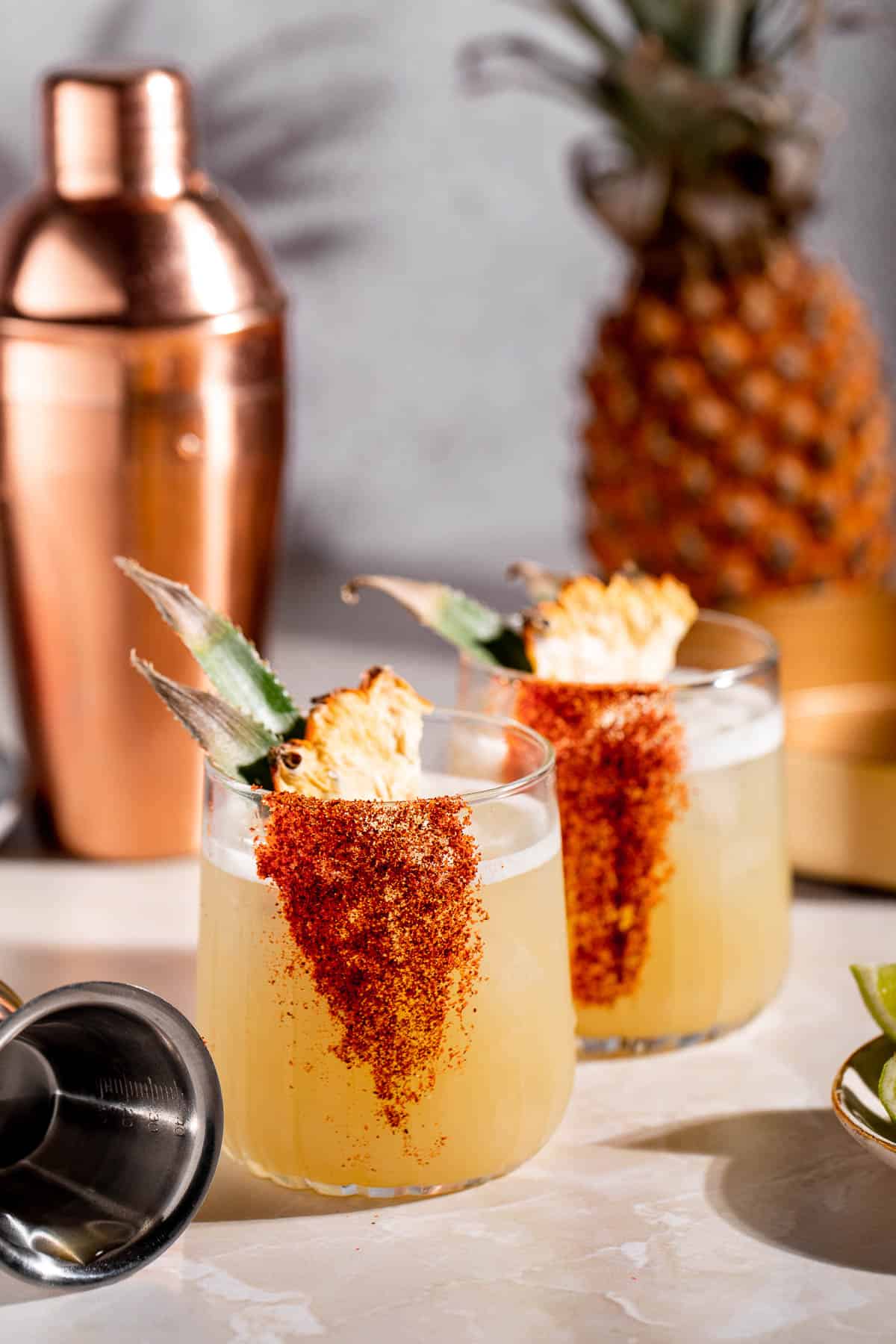 mezcalita cocktail with golden cocktail shaker and pineapple