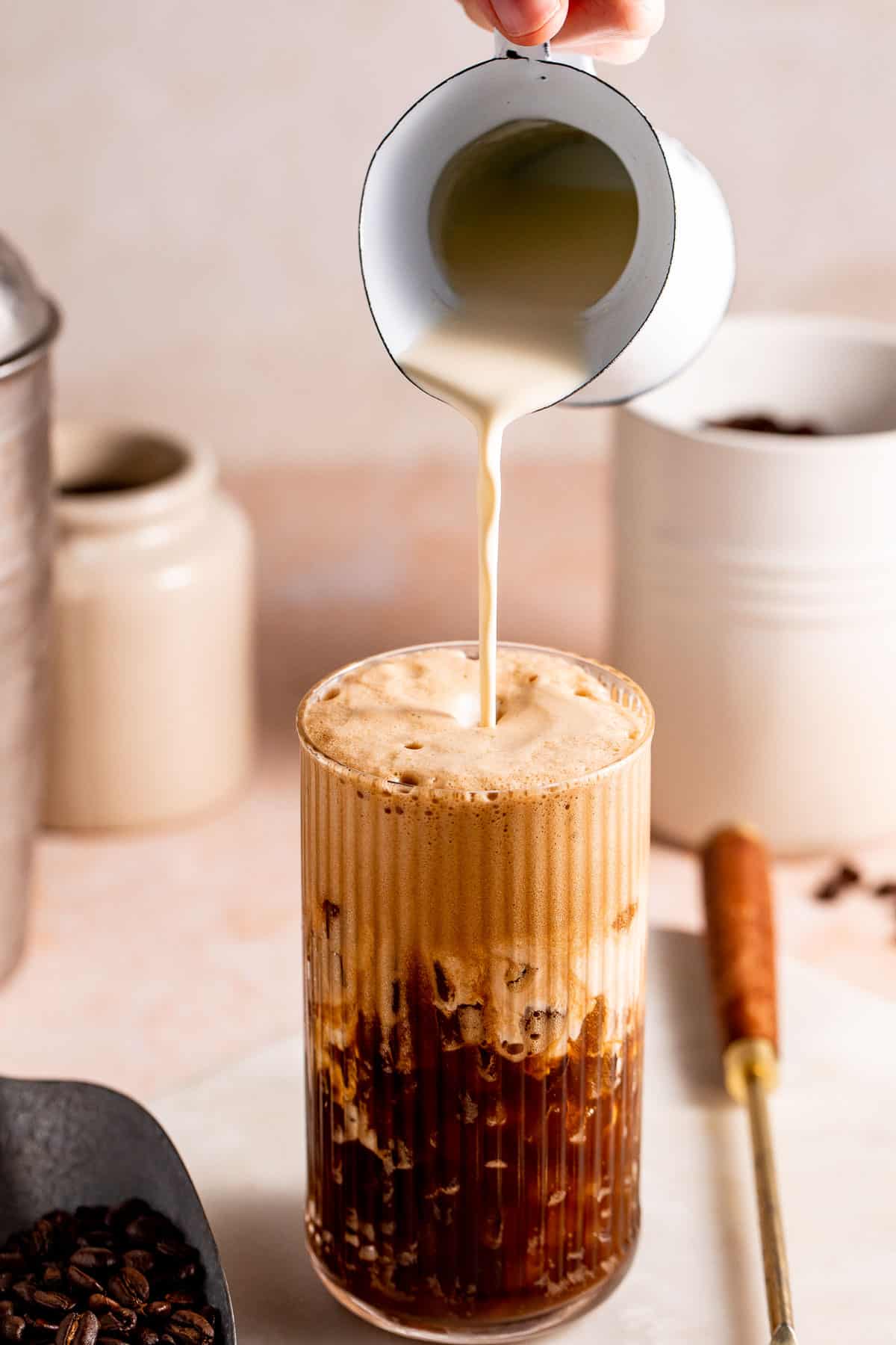 Milk pouring into a coffee drink.