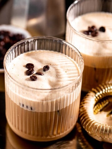 ribbed glasses on gold tray filled with shaft drink and topped with coffee beans