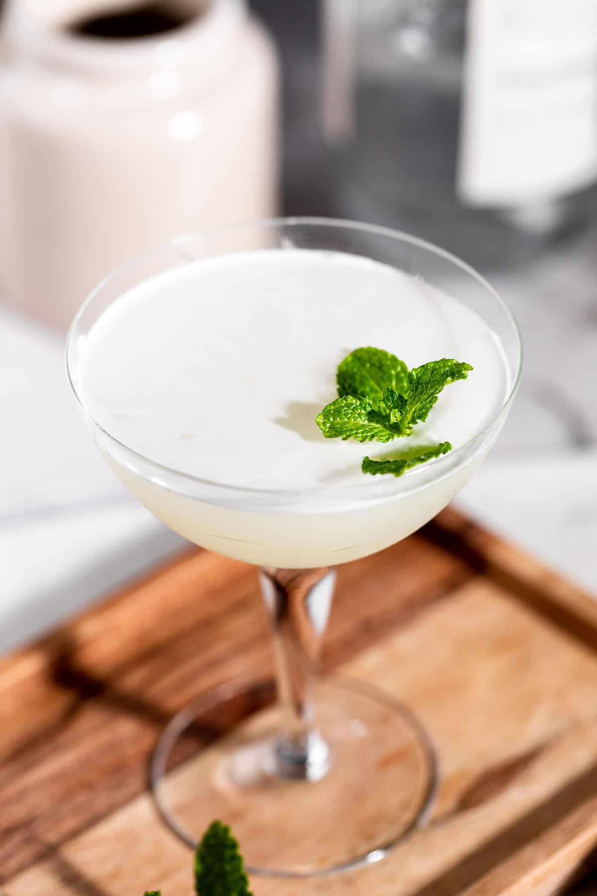 A South Side Cocktail in a serving glass garnished with fresh mint.