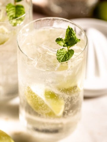 tequila and sprite in highball glass with lemon and mint