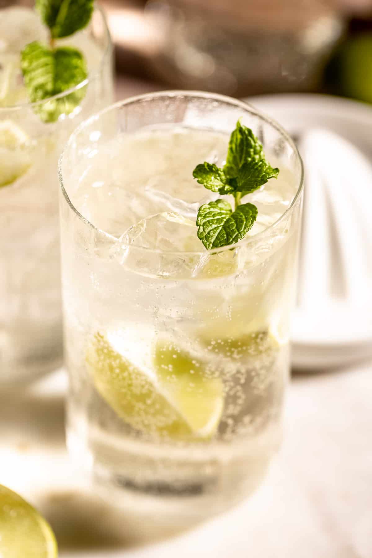 tequila and sprite in highball glass with lemon and mint