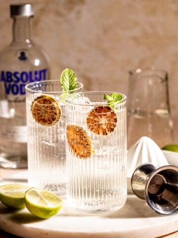vodka and sprite in highball glasses with dehydrated orange slices